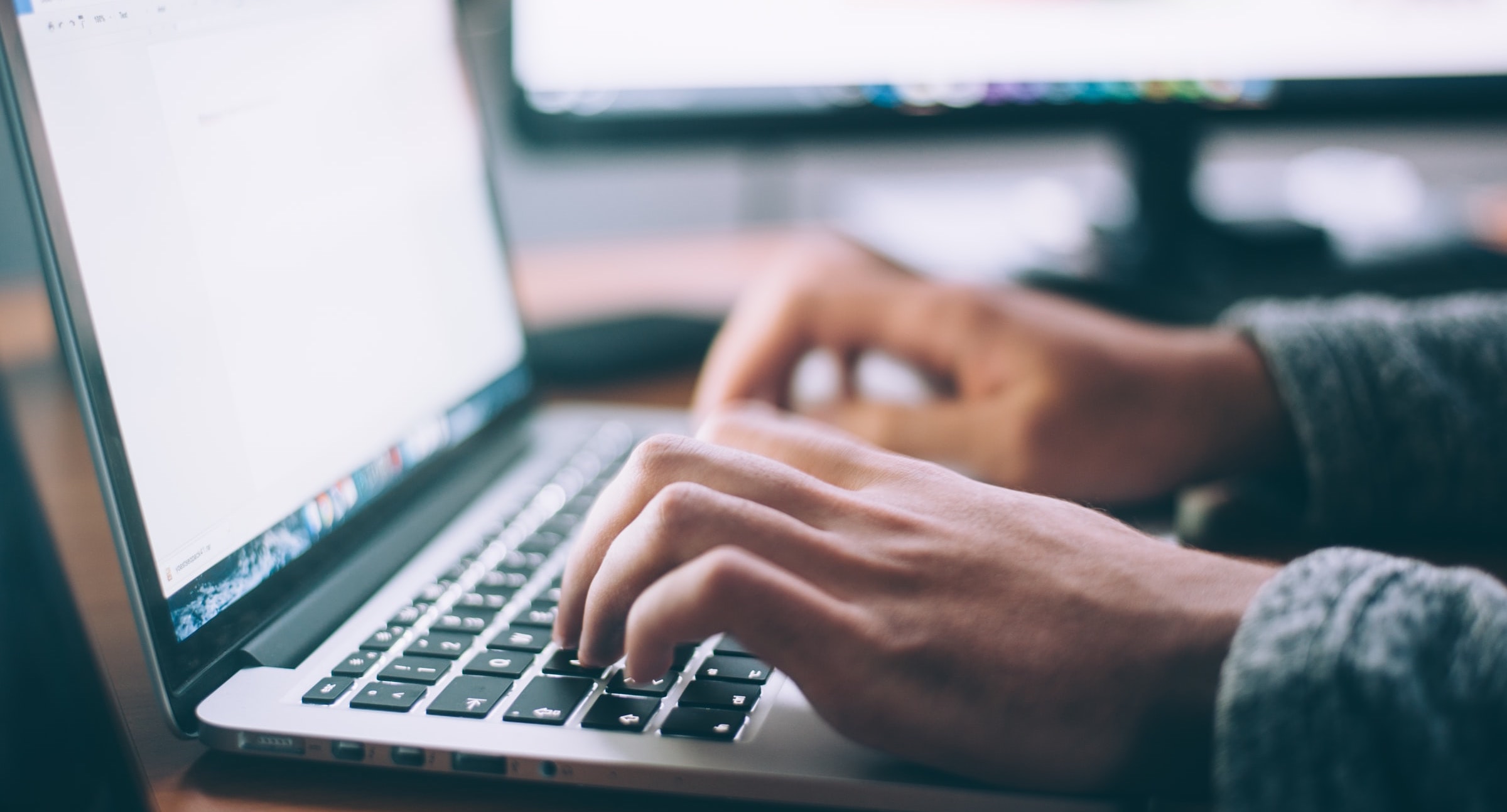 a person typing on a laptop