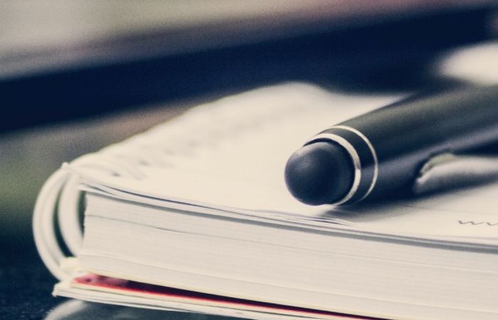 a pen on top of a notepad